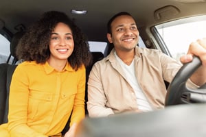 joyful-black-couple-enjoying-travel-by-car-sitting-2023-11-27-05-23-00-utc